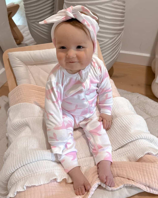 Baby in a pink whale romper
