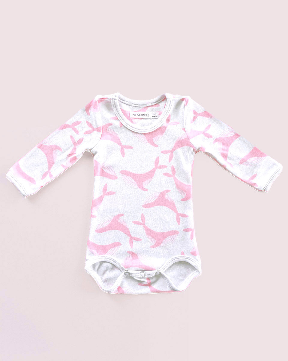 Baby onesie with pink and white pattern on a light pink background
