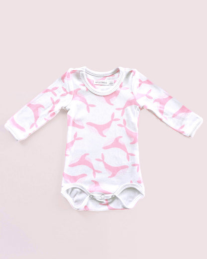 Baby onesie with pink and white pattern on a light pink background